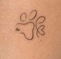 a small tattoo on the back of a woman's arm with an animal symbol