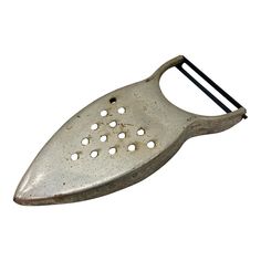 an old metal grater with holes in it