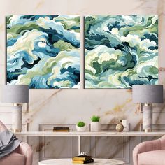 two paintings on the wall in a living room