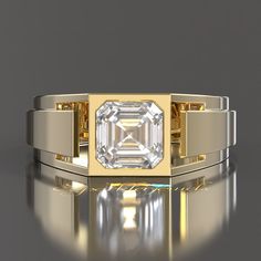 a yellow gold ring with an emerald cut diamond in the center on a reflective surface