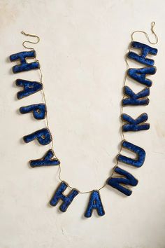 a blue necklace with the word thank written on it