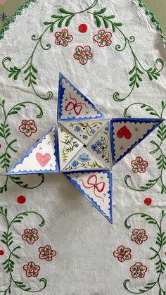 an origami bird is sitting on a table cloth