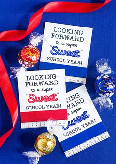 some candy wrapped in red, white and blue ribbon on top of a blue table