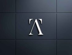 the letter a is made up of white letters on a black tile wall, and it appears to be cut in half