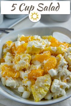 a white bowl filled with fruit salad on top of a table