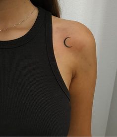 a woman with a crescent tattoo on her shoulder