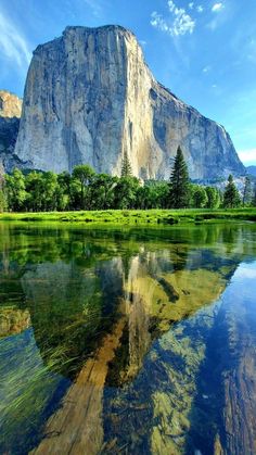 the mountains are reflected in the clear water