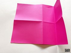 an origami cat made out of pink paper on a white surface with text overlay