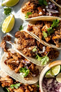 shredded pork tacos with onions, cilantro and lime