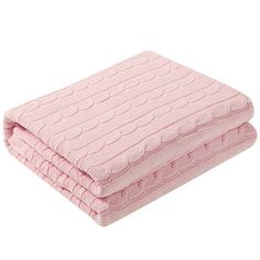 the pink blanket is folded on top of each other