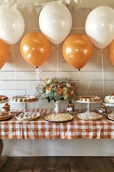 a table topped with lots of desserts and balloons