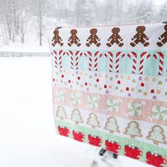 a quilt hanging on a clothes rack in the snow