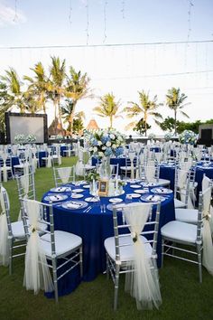 an outdoor wedding setup with blue and white linens