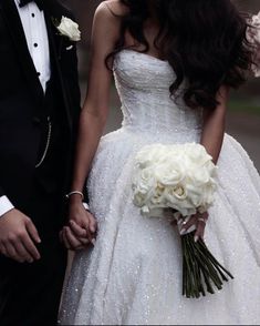 the bride and groom are holding hands