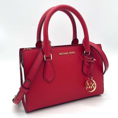 Brand New With Tag Michael Kors Sheila Small Satchel Shoulder Crossbody Bag Vegan Leather Gold Toned Hardware Color: Bright Red 100% Authentic **Please See The Measurement For The Size** No Dust Bag Michael Kors Logo At Front 1 Mk Charm Zip Top Closure Triple Compartment With Center Zip Custom Fabric Lining 1 Slip-In Pocket 9" (Bottom) X 6.5"(H) X 3"(D) Straps: 3.5" Adjustable Strap: 20.25"-23.75" Brown Satchel, Michael Kors Satchel, Michael Kors Logo, Bag Michael Kors, Handbag Collection, Girly Bags, Bags Michael Kors, Leather Satchel Bag, Satchel Tote