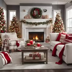 a living room decorated for christmas with white couches and red and gold decorations on the fireplace