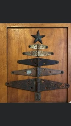 a christmas tree made out of old rusty metal pieces on a door handle with a star hanging from the top