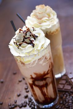 two drinks with whipped cream and chocolate on top