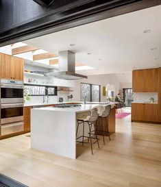 an open kitchen and dining room with wood flooring