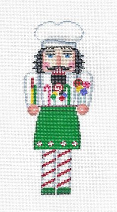 a cross stitch pattern of a man in green overalls and white hat with candy cane