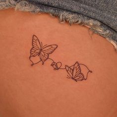 a woman's stomach with two butterflies on it