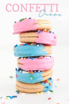 a stack of cookies covered in frosting and sprinkles on top of each other