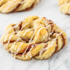 cinnamon roll cookies with icing on a marble surface