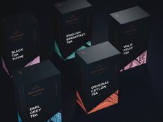 six black tea boxes sitting on top of each other in front of a dark background