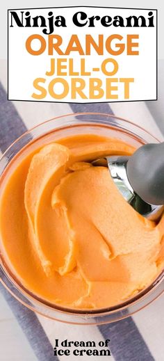 an orange jello sorbet in a glass bowl with a spoon