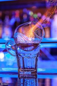 a glass cup filled with liquid sitting on top of a table