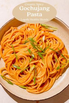 a bowl filled with noodles and sauce on top of a table