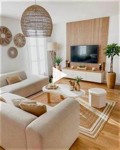 a living room filled with furniture and a flat screen tv on top of a wooden table