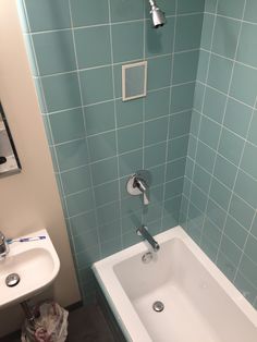 a bathroom with blue tiled walls and floor