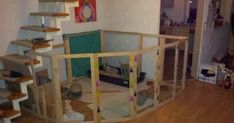 a living room filled with furniture and lots of wood flooring next to a stair case