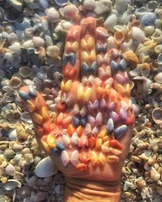 a person's hand is covered in shells