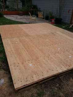 a large wooden floor laying in the grass