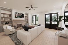 a living room filled with furniture and a fire place in the middle of a room