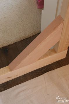 a piece of wood sitting on top of a wooden floor next to a door frame