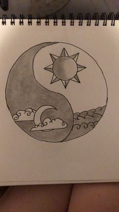 a drawing of a sun and moon in the sky