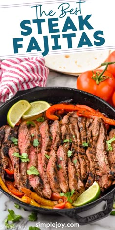 steak fajitas in a cast iron skillet with limes and tomatoes on the side