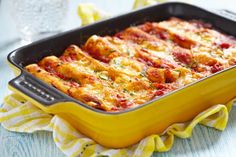 a yellow casserole dish filled with meat and cheese