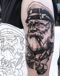 a black and white photo of a man with a santa clause tattoo on his arm