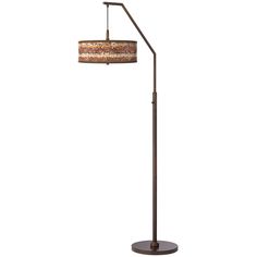 a floor lamp with a brown shade on it's side and a white background