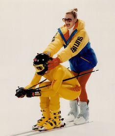 two women in yellow and blue ski suits