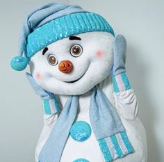 a stuffed snowman wearing a blue hat and scarf with one hand up to his ear