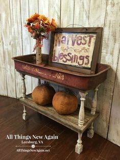 an old wooden shelf with two pumpkins on it and a sign that says harvest blessing