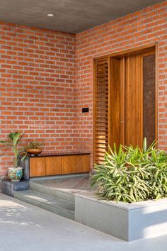 a planter is in front of a door on the outside of a brick building