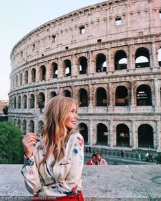 a woman standing in front of the colossion with her hand on her hip