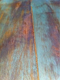 an old wooden table with rusted paint on the top and bottom surface, as seen from above