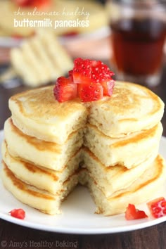 a stack of pancakes with strawberries on top